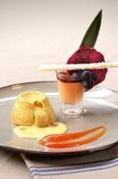 vanilla petit gateau with guava syrup and papaya cream photo