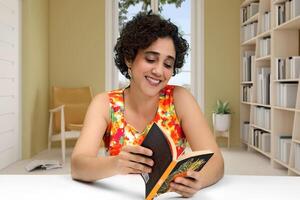 young woman reading and writing at her desk photo