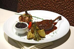 duck with garlic, potatoes and grape jelly photo