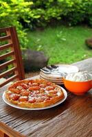 Tarte tartin with plates and cutlery on the table photo