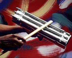 hands playing Brazilian batucada instruments in close-up photo