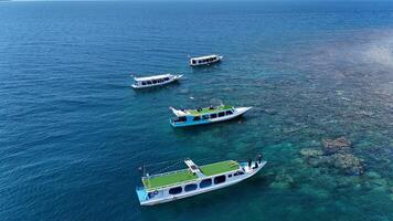 Top view or aerial view of Beautiful crystal clear water and white beach with long tail boats in summer of tropical island photo