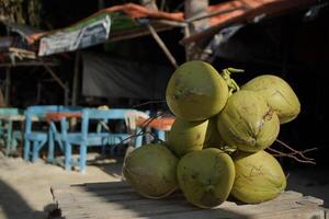 Bunch of green young coconut fruit on a beach photo