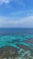 Panoramic view of blue calm sea and blue clear sky in the summer afternoon at the coast of a tropical island photo