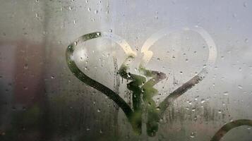 the sign of a broken heart on the dewy glass photo