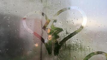 the sign of a broken heart on the dewy glass photo