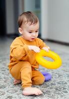 Small playful child activities. Little boy playing with toys. photo