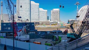 A timelapse of crane at the under construction in Yokohama tilt video