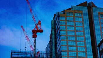 A timelapse of cranes at the under construction on the building in Tokyo video