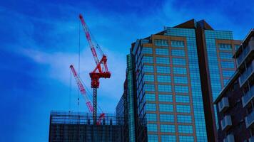 A timelapse of cranes at the under construction on the building in Tokyo video