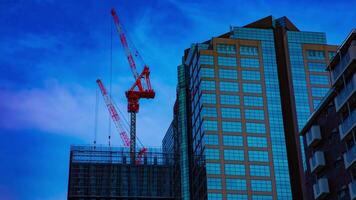 A timelapse of cranes at the under construction on the building in Tokyo video