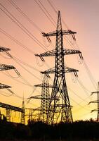 Electricity engineering constructrions supply. Dark shadows of electrical power towers. photo