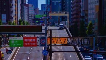 A timelapse of traffic street at the highway entrance in Tokyo long shot tilt video