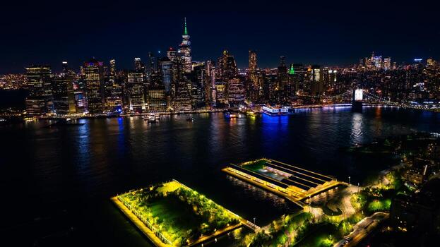 fantásticamente iluminado nuevo York desde aéreo perspectiva. zumbido volador terminado el deslumbrante ciudad panorama a noche. foto