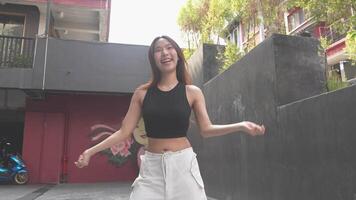 Young Asian woman walking and dancing in the city. Style. Hip hop and freestyle. video