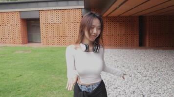 Young Asian woman walking and dancing in the city. Style. Hip hop and freestyle. video