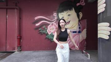 Young Asian woman walking and dancing in the city. Style. Hip hop and freestyle. video