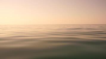 Sea water surface. Low angle view from kayak, camera flies over clear sea water. Nobody. Holiday recreation concept. Abstract nautical summer ocean nature. Slow motion. Close up. Vertical video