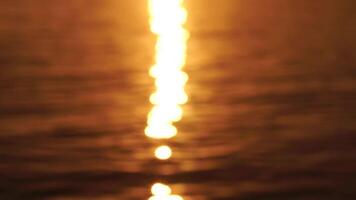 Sea water surface sunset. Low angle view over golden sea water. Sun glare. Abstract nautical summer ocean nature. Holiday, vacation and travel concept. Nobody. Slow motion. Weather and climate change video