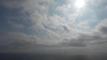 Timelapse fluffy Cumulus clouds moving in bright golden sunset sky over sea. Abstract aerial nature summer ocean sunset, sea and sky view. Vacation, travel, holiday concept. Weather and Climate Change video