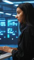 Vertical Technician working in high tech server room, analyzing data on multiple monitors, ensuring seamless data flow. Woman examining racks in data center, ensuring system integrity and security video