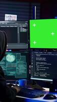 Vertical Hacker coding on isolated screen computer monitors, developing zero day exploit undetectable by antivirus. Evil IT engineer using chroma key PC displays to build script tricking firewalls, camera B video