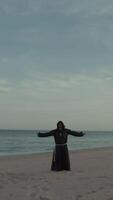 Monk Makes A Spiritual Religious Connection Open Arms At Lonely Beach Near Sea video