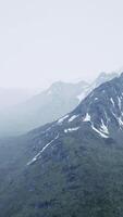 Awesome top view through clouds to high snowy mountains video