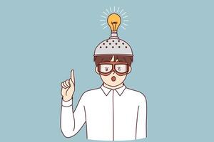 Inspired boy invented new idea and shows finger up standing with funny helmet with light bulb vector