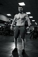 Muscular shirtless man training hard. Sportive lifestyle motivation concept. photo