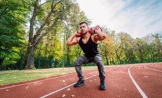 Sporty muscular training man outdoor. Young handsome cardio workout. photo