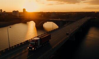 Truck driving on bridge at sunset photo