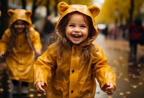 Happy children in raincoats walking in the rain photo
