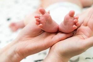 Baby feet in mother arm. Newborn baby feet photo