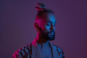 Black man in neon studio light photo