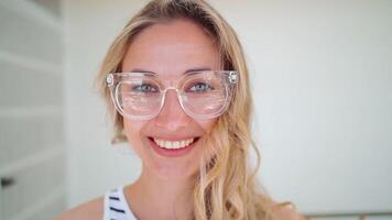 Happy woman wearing trendy eyeglasses on beige wall video