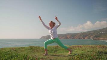 55-Year-Old Woman Practicing Yoga by the Ocean video