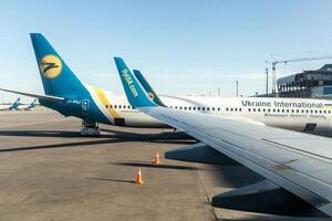 Passenger plane UIA Ukrain International Airlines in the airport . Aircraft maintenance. Airport Borispil Kiev Ukraine May 2018 photo