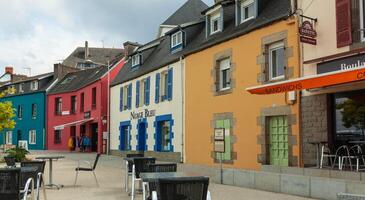 morgat, Francia 29 mayo 2018 hermosa ver de escénico estrecho callejón con histórico tradicional casas y adoquinado calle en un antiguo pueblo en Europa con azul cielo y nubes en verano foto