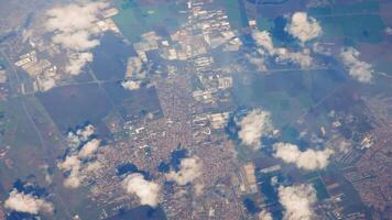 Aerial view of city and fields, High-altitude aerial view of a city surrounded by agricultural fields. video