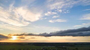 Green meadow under a blue sunset sky with clouds photo