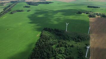 Windmills in summer in a green field.large windmills standing in a field near the forest.Europe, Belarus photo