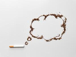 Cigarette with tobacco shaped into speech bubble on white background, representing quitting smoking and health awareness concept. No tobacco day. photo