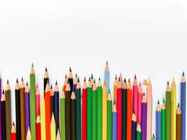 Assorted colored pencils lined up on white background with space for text. Creative concept for art, education, and design advertising banner for school products with empty space. photo