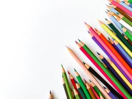 Assorted sharpened colorful pencils pointing up on white background with copy space for text. Concept of artistic or school supplies for design, teaching and educational purposes. photo