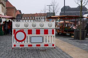 Plastic red and white barrier with a stop signal fume resurrecting entry to the peasant market. photo