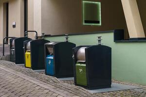 Stylish metal trash containers near the building photo