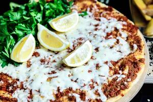 Close-Up of Pizza With Lemons and Parsley photo