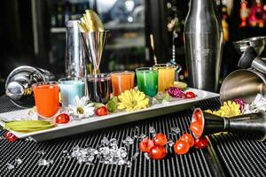 Tray of Drinks on Bar With a Bottle of Wine photo