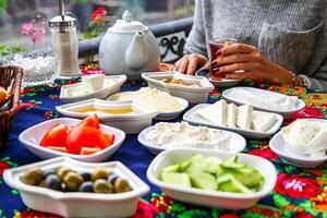 Woman Sitting at Table Filled With Bowls of Food photo